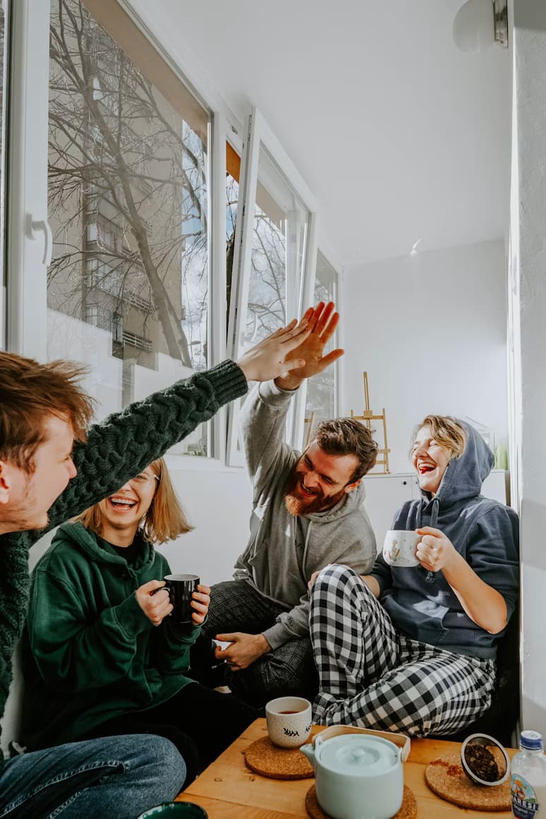 A small group of friends sharing a warm meal together, laughing and connecting
